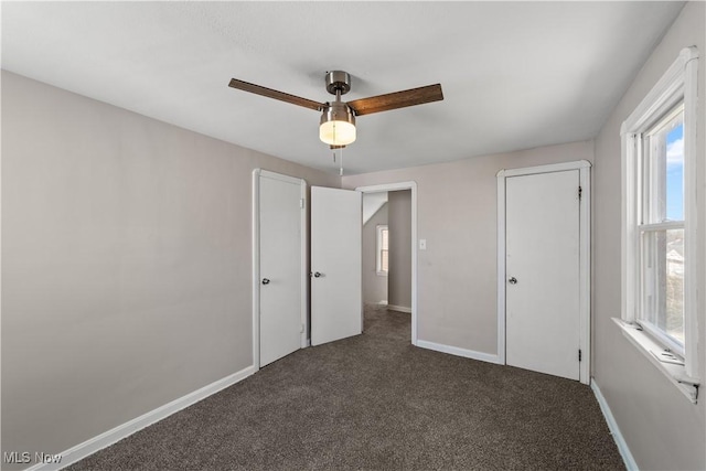 unfurnished bedroom featuring ceiling fan, baseboards, and carpet floors