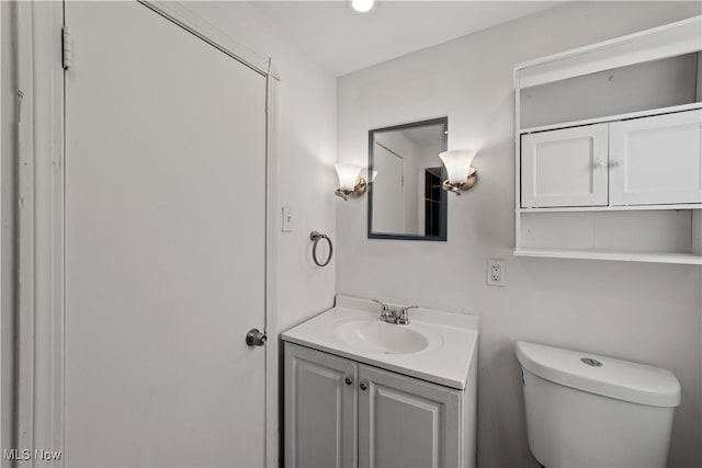 half bathroom featuring toilet and vanity