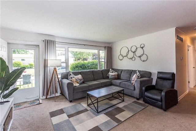 living room featuring light colored carpet and healthy amount of natural light