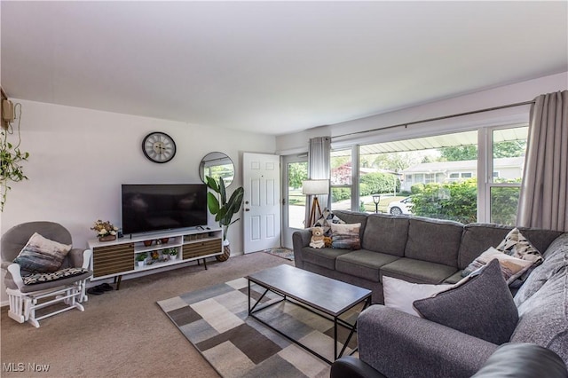 carpeted living room with baseboards