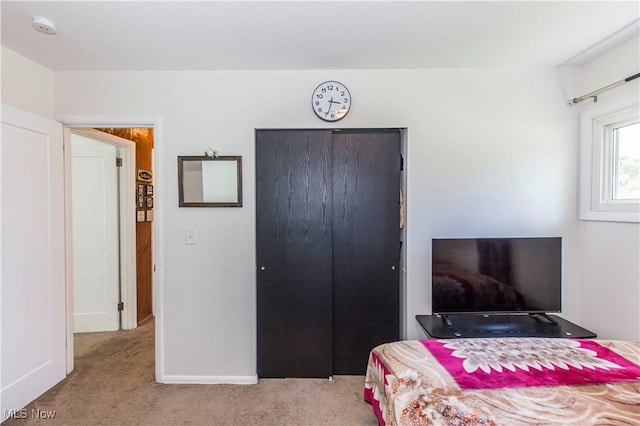 bedroom with a closet, carpet floors, and baseboards