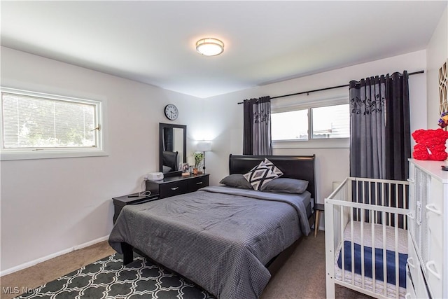carpeted bedroom featuring baseboards