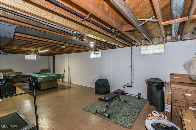 below grade area featuring pool table and concrete block wall
