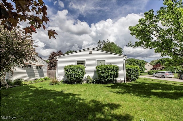 view of side of home featuring a yard