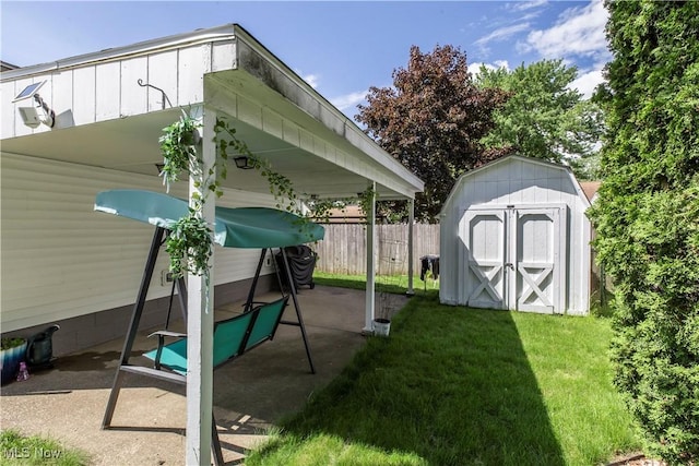 view of yard featuring a storage shed, a patio, and an outdoor structure