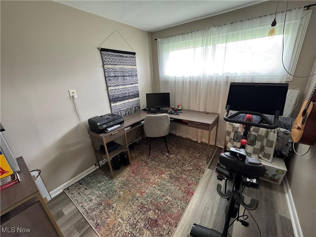 office area with baseboards and wood finished floors