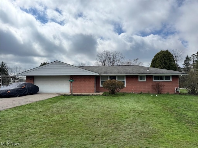 ranch-style home featuring an attached garage, driveway, a front yard, and brick siding