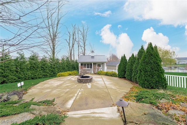 4643 Pebble Creek Ct, Peninsula, OH 44264 - view of front of home with an outdoor structure, a patio, an outdoor fire pit, and metal roof