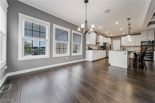 4643 Pebble Creek Ct, Peninsula, OH 44264 - kitchen with stainless steel appliances, a chandelier, backsplash, a kitchen breakfast bar, and recessed lighting