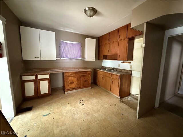 3893 E 55th St, Cleveland, OH 44105 - kitchen featuring a sink, brown cabinetry, and dark countertops