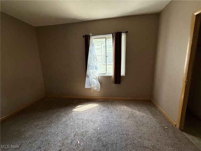 3893 E 55th St, Cleveland, OH 44105 - carpeted spare room featuring baseboards
