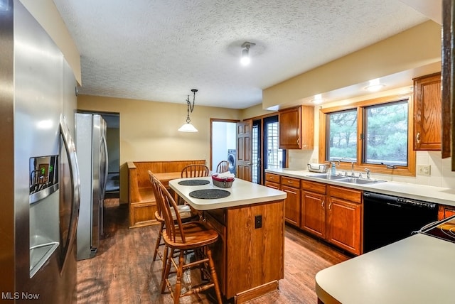 kitchen with a sink, a kitchen island, black dishwasher, and dark wood-style floors