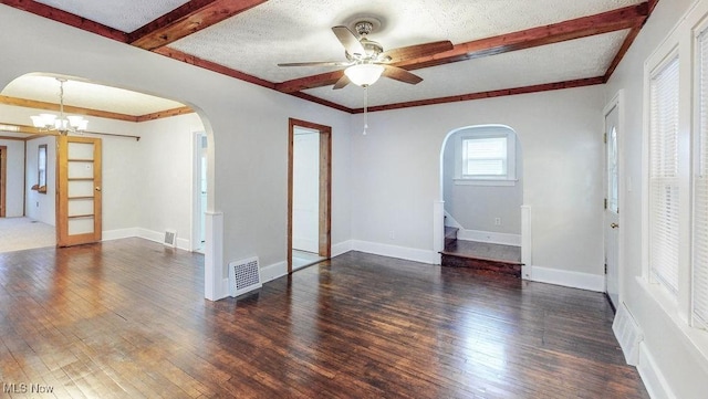 unfurnished room featuring visible vents, arched walkways, and hardwood / wood-style flooring