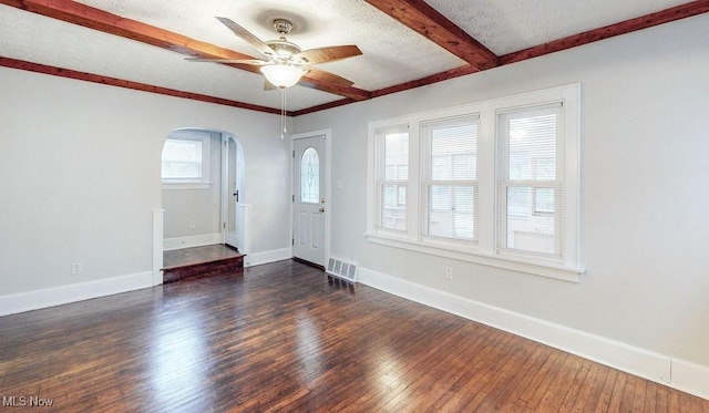 entrance foyer with a ceiling fan, visible vents, beam ceiling, arched walkways, and hardwood / wood-style flooring