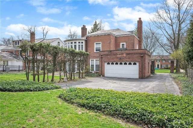 2691 Rocklyn Rd, Shaker Heights, OH 44122 - view of side of property with an attached garage, fence, driveway, and a chimney