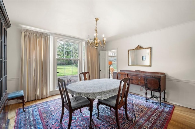 2691 Rocklyn Rd, Shaker Heights, OH 44122 - dining space with a notable chandelier, ornamental molding, and light wood-style flooring