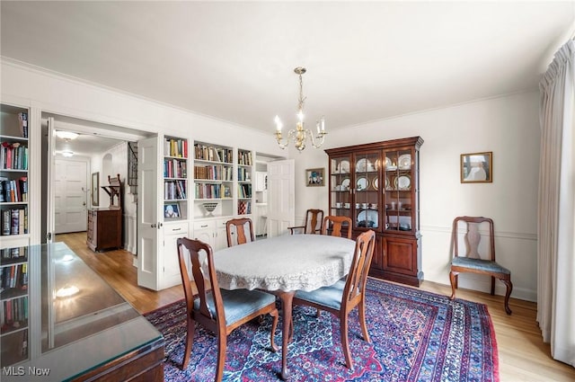 2691 Rocklyn Rd, Shaker Heights, OH 44122 - dining room featuring a chandelier, light wood-style floors, and crown molding