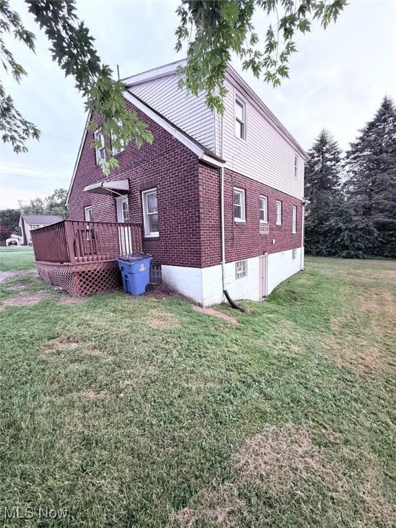 270 Coitsville Rd, Campbell, OH 44405 - view of side of property featuring brick siding, a lawn, and a deck