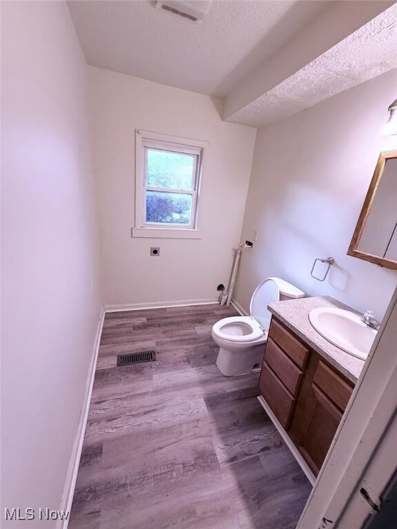 270 Coitsville Rd, Campbell, OH 44405 - bathroom with vanity, wood finished floors, and a textured ceiling
