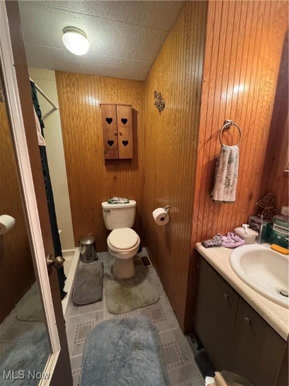 1110 3rd St, Belpre, OH 45714 - bathroom with a stall shower, vanity, and wood walls