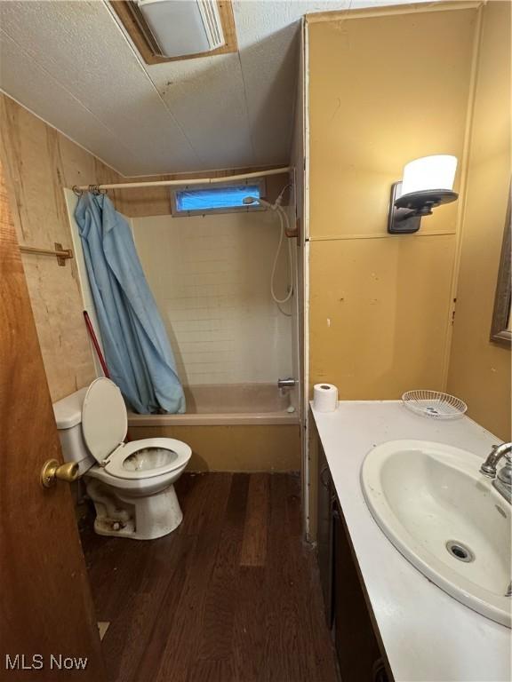 1110 3rd St, Belpre, OH 45714 - bathroom with shower / tub combo, wood finished floors, and vanity