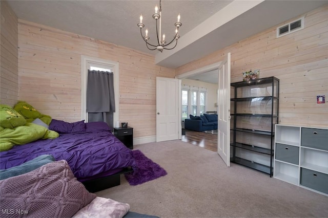 1733 State Route 303, Streetsboro, OH 44241 - bedroom featuring wooden walls, carpet flooring, a chandelier, and french doors