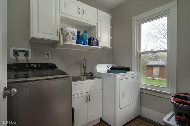 laundry room featuring a sink, cabinet space, washing machine and dryer, and plenty of natural light