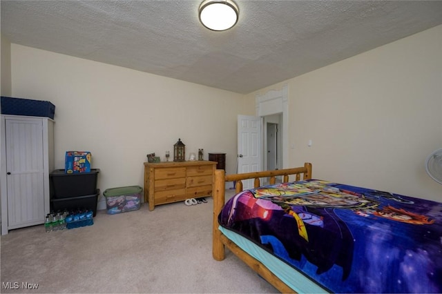carpeted bedroom with a textured ceiling