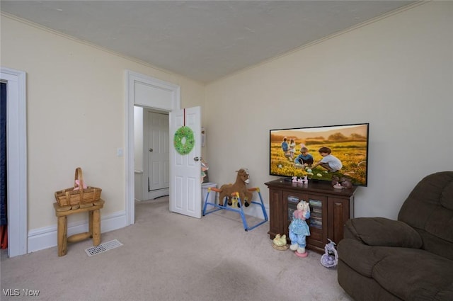 living room with carpet flooring, visible vents, baseboards, and ornamental molding