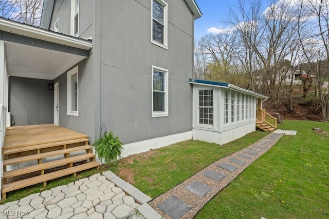 view of side of property with a yard