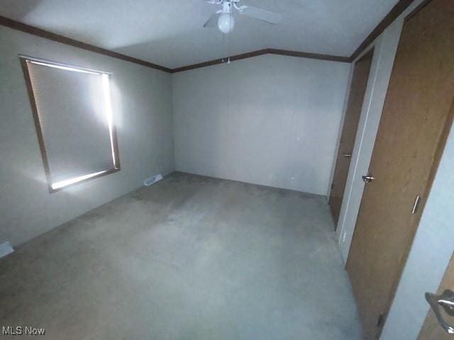 unfurnished bedroom with ceiling fan, ornamental molding, and lofted ceiling