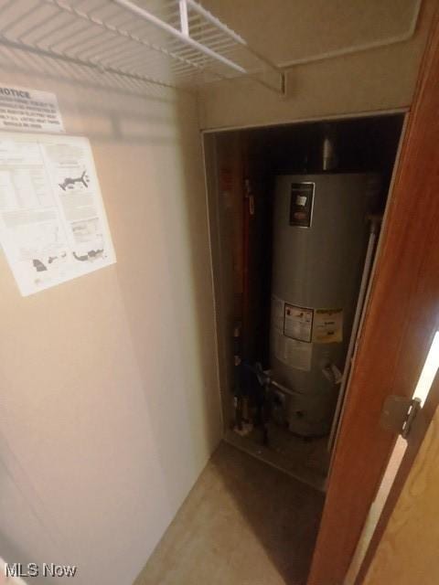 utility room featuring water heater