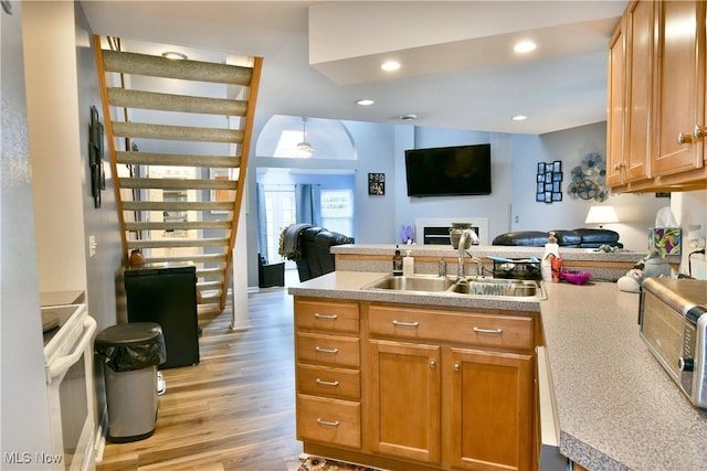 345 S Linden Ct, Warren, OH 44484 - kitchen featuring white electric range, light wood-style flooring, a peninsula, a sink, and open floor plan