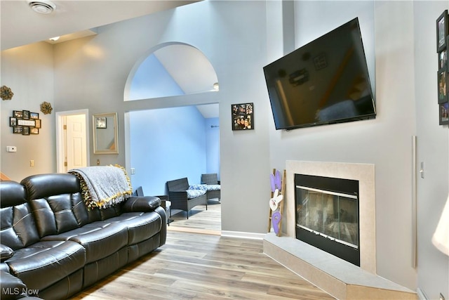 345 S Linden Ct, Warren, OH 44484 - living room with a glass covered fireplace, a high ceiling, and wood finished floors