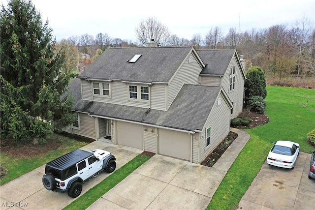 345 S Linden Ct, Warren, OH 44484 - traditional-style home with a chimney, a front lawn, driveway, and roof with shingles