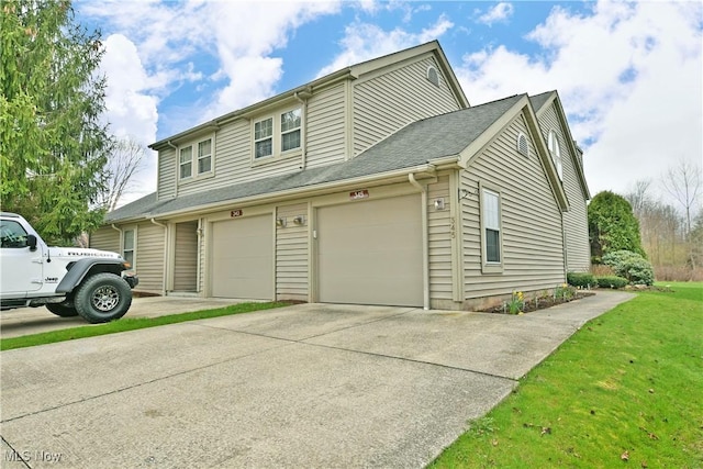 345 S Linden Ct, Warren, OH 44484 - view of property exterior with driveway, a lawn, and a garage