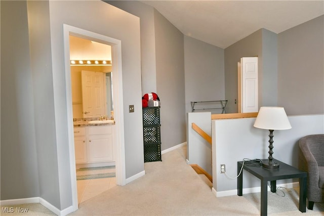 345 S Linden Ct, Warren, OH 44484 - hall with a sink, vaulted ceiling, light colored carpet, and baseboards
