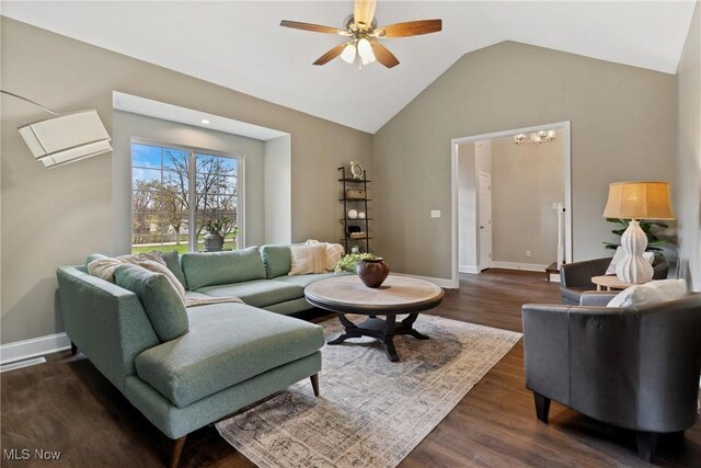 living room featuring visible vents, an AC wall unit, ceiling fan with notable chandelier, dark wood-type flooring, and lofted ceiling