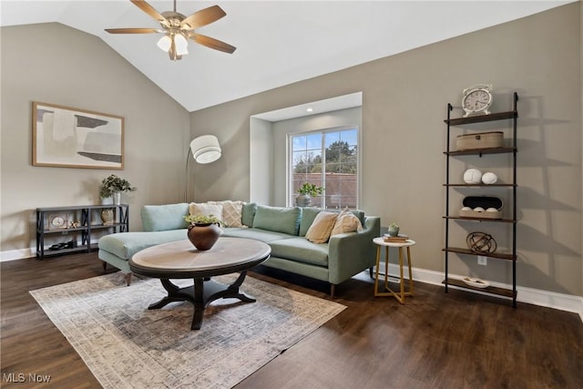living room featuring baseboards, a ceiling fan, vaulted ceiling, and dark wood-style floors