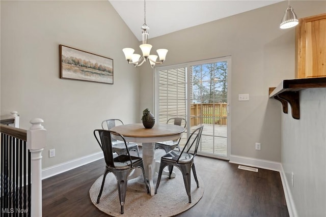 dining area featuring baseboards, a chandelier, vaulted ceiling, and dark wood finished floors