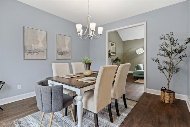 dining area with baseboards, a chandelier, and wood finished floors