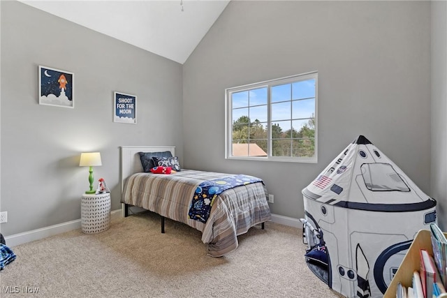 carpeted bedroom featuring high vaulted ceiling and baseboards