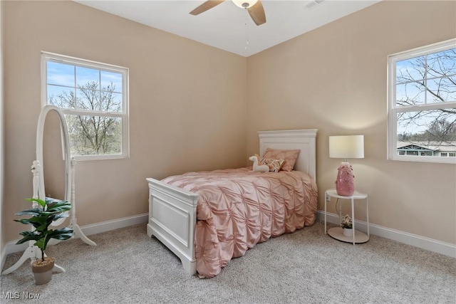 bedroom with baseboards, a ceiling fan, and carpet