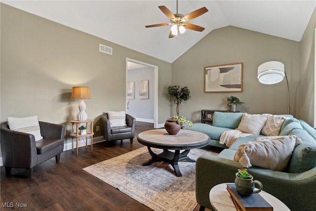 living area featuring baseboards, dark wood-type flooring, visible vents, lofted ceiling, and ceiling fan