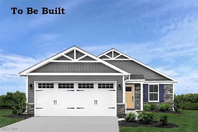 34733 Maurer Blvd, Grafton, OH 44044 - craftsman inspired home with a garage, a front yard, stone siding, and concrete driveway
