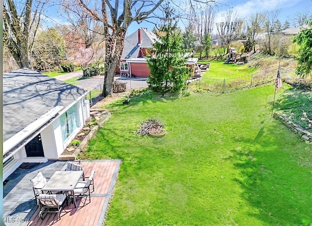 view of yard featuring fence and a deck