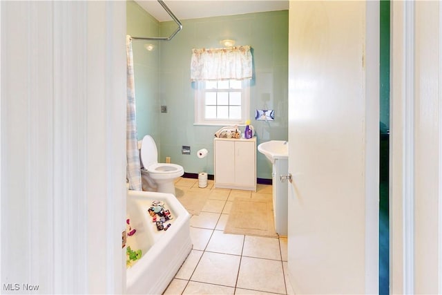 bathroom featuring a shower with curtain, a bathing tub, toilet, vanity, and tile patterned floors