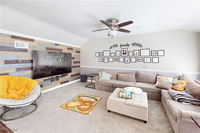 carpeted living room with visible vents, baseboards, a ceiling fan, and vaulted ceiling