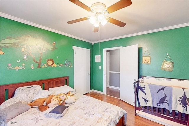 bedroom with ceiling fan, baseboards, crown molding, and wood finished floors