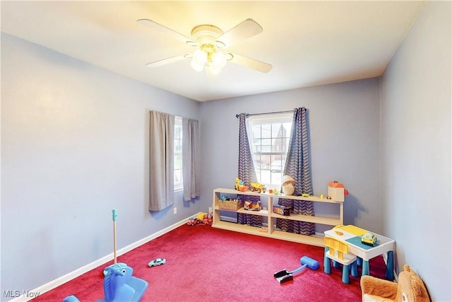 rec room with carpet flooring, baseboards, and ceiling fan